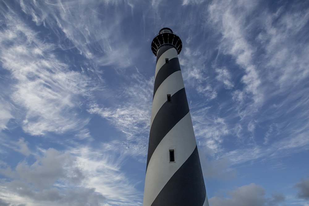 white and black striped lighthouse under blue sky during daytime