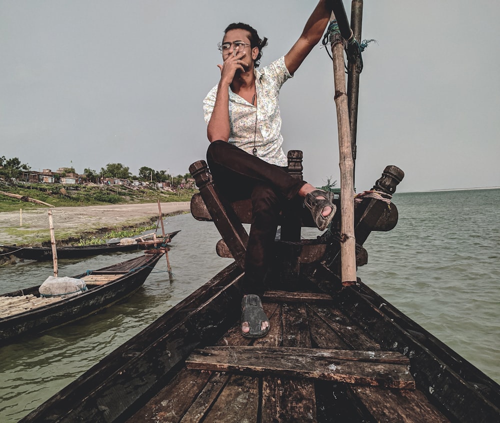 woman in white sleeveless dress sitting on brown wooden dock during daytime