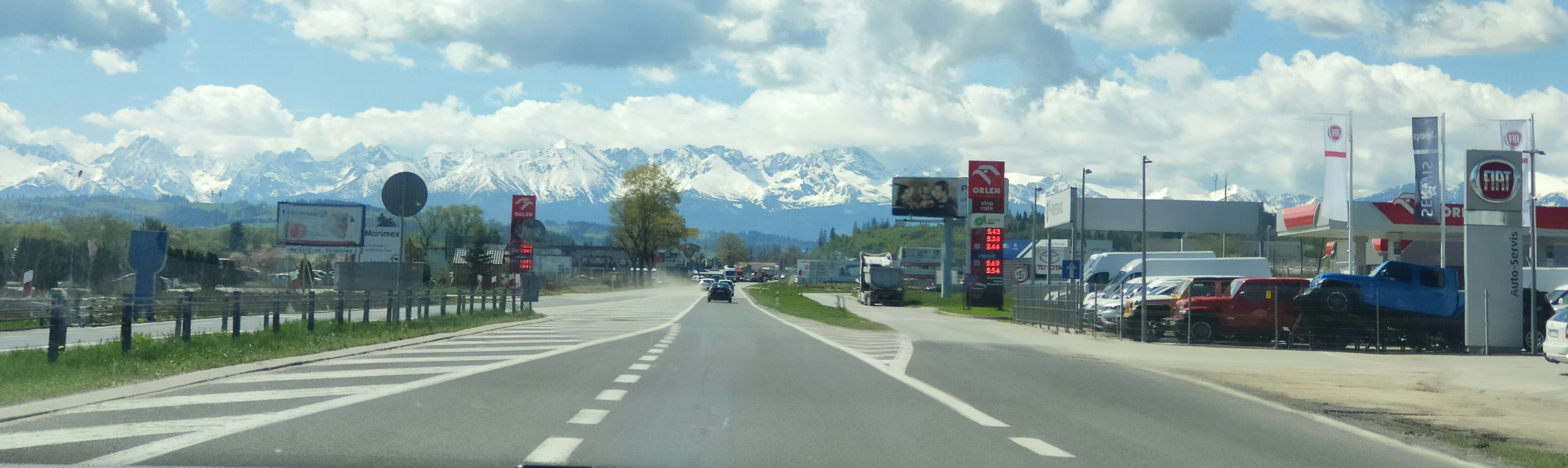 a car driving down a street next to a traffic light