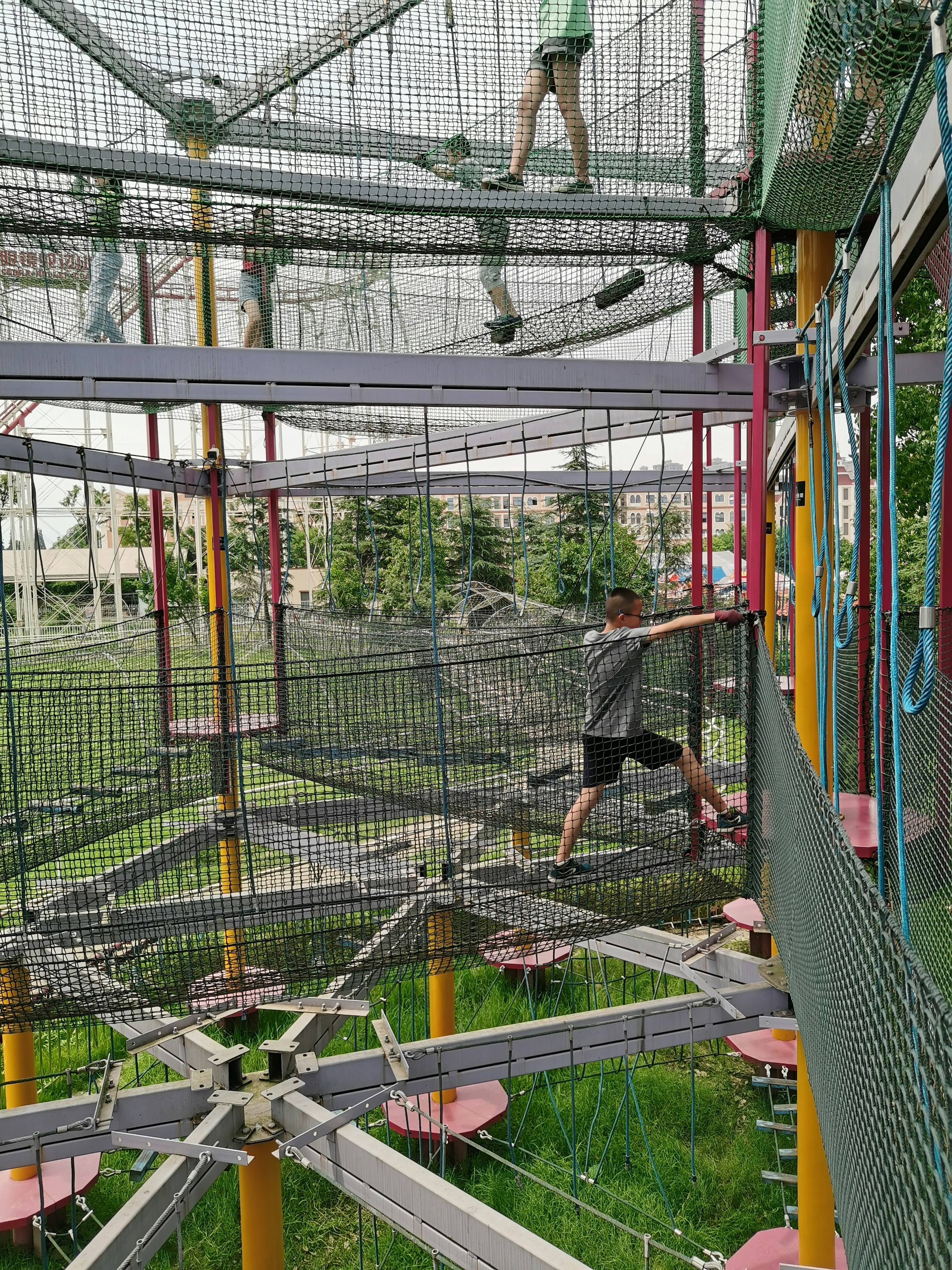 Thumbnail 2 of Kids enjoying rope bridge adventure course inside the venue