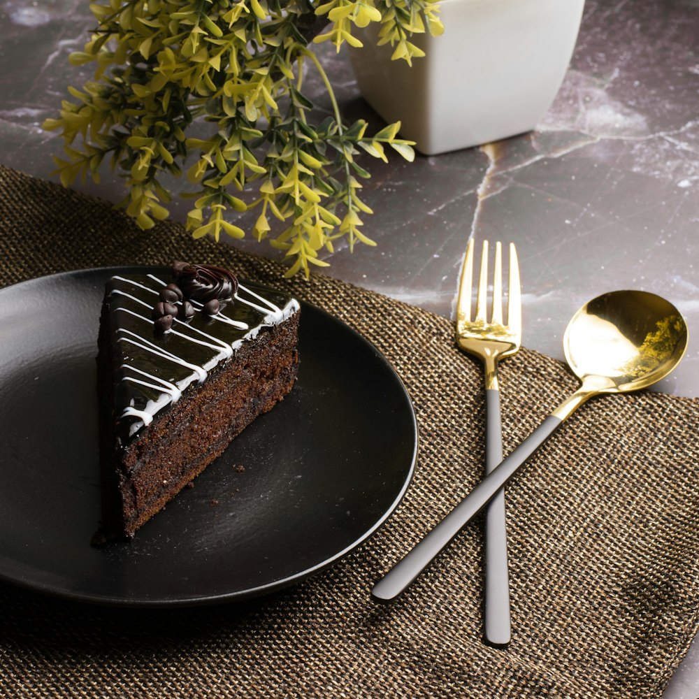 chocolate cake on black plate with fork