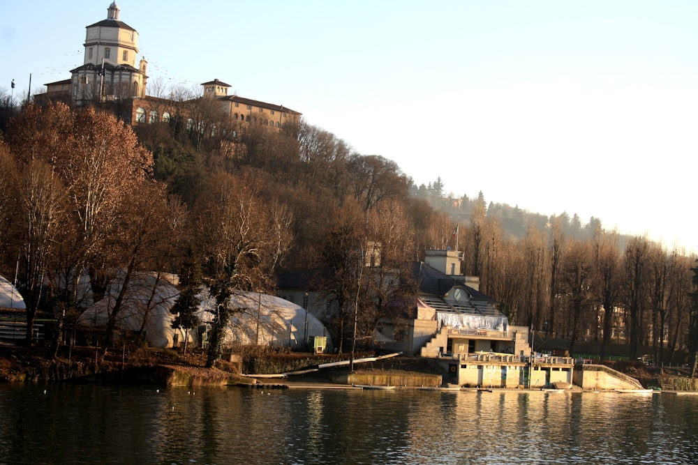 white and brown concrete building near body of water during daytime