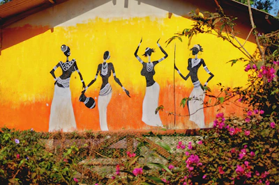 A vibrant mural depicting themes of migration and human rights in a Central American neighborhood.