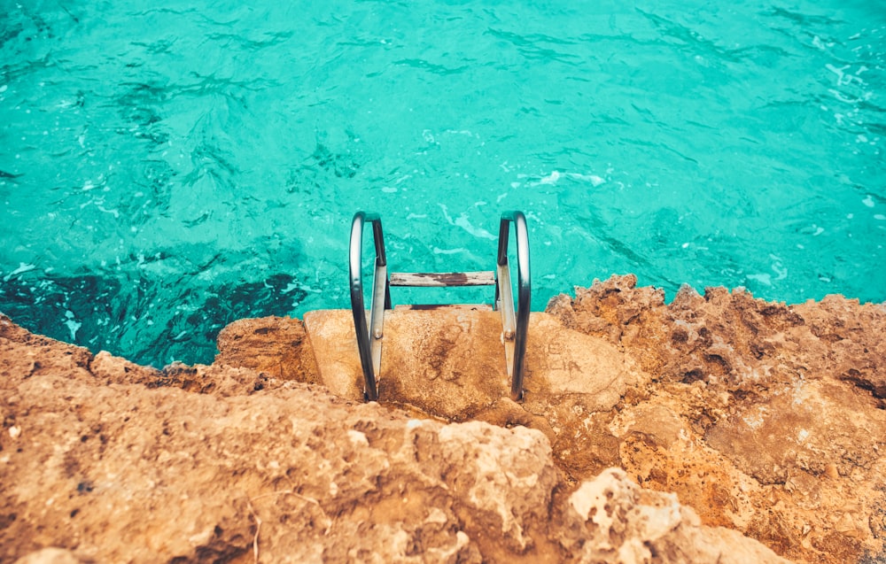 black and gray swimming ring on brown rock