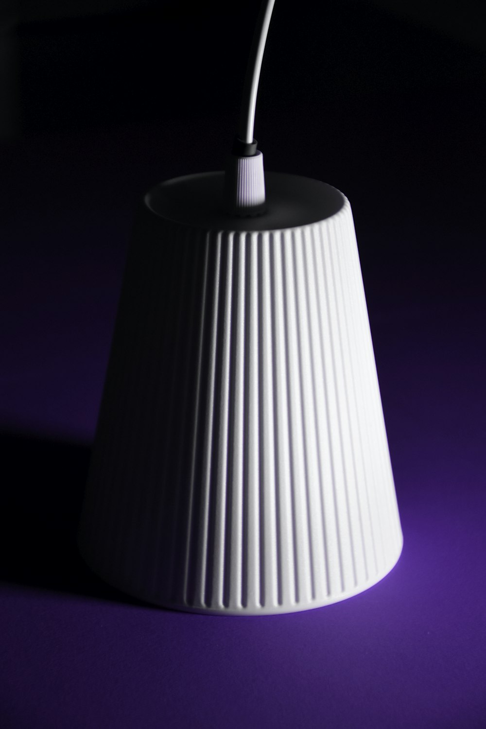 white pendant lamp turned on in dark room