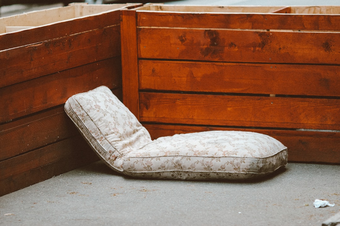 brown wooden bench near brown wooden fence