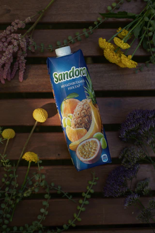 A colorful assortment of Vitalora's food supplements displayed on a rustic wooden table with fresh fruits and herbs.