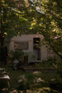 Close-up of a cozy caravan deck with outdoor seating under soft evening light.