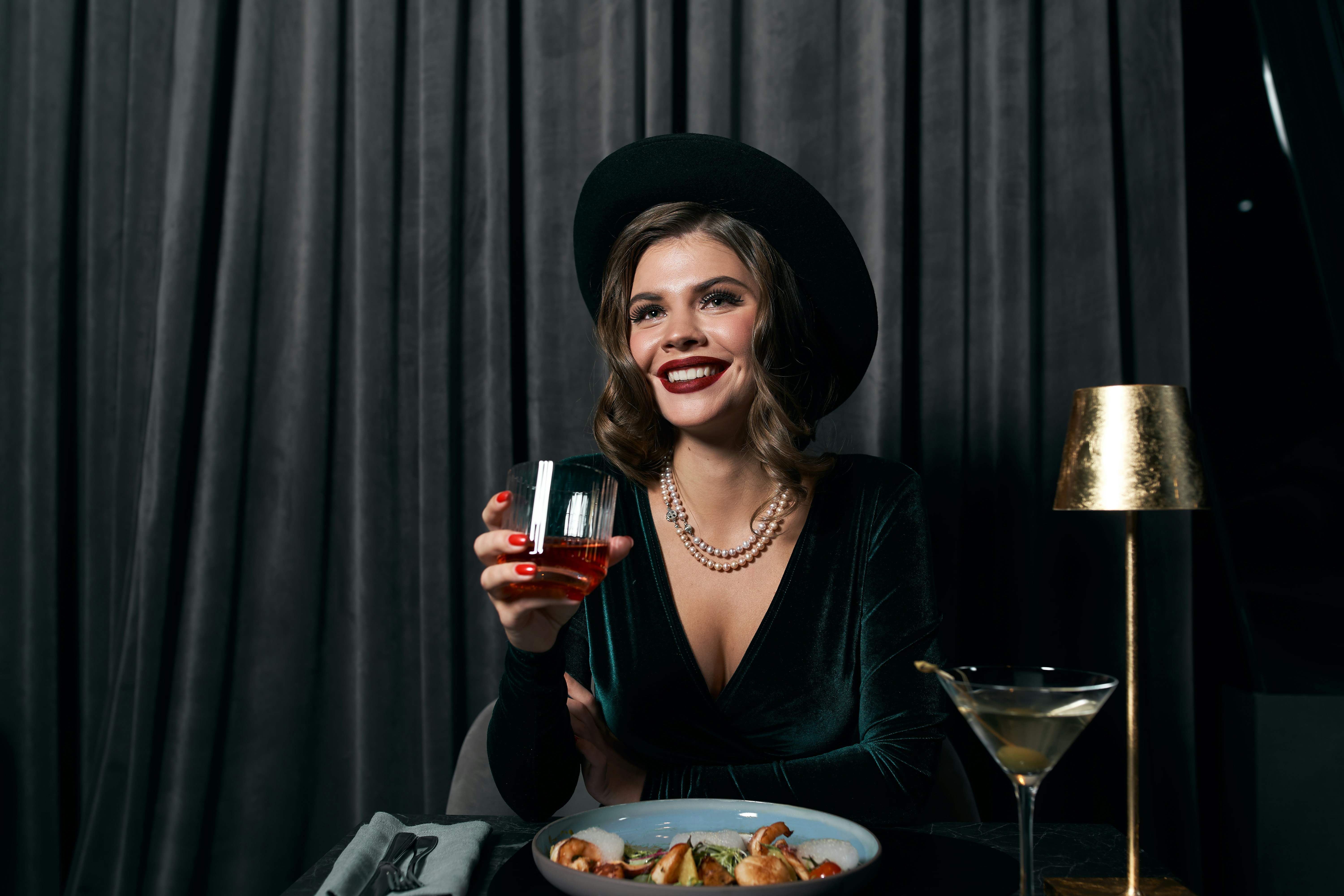 woman in black long sleeve shirt holding wine glass