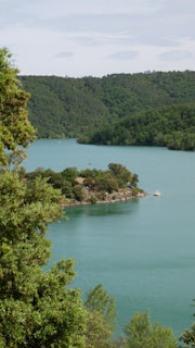 person riding on boat on lake during daytime
