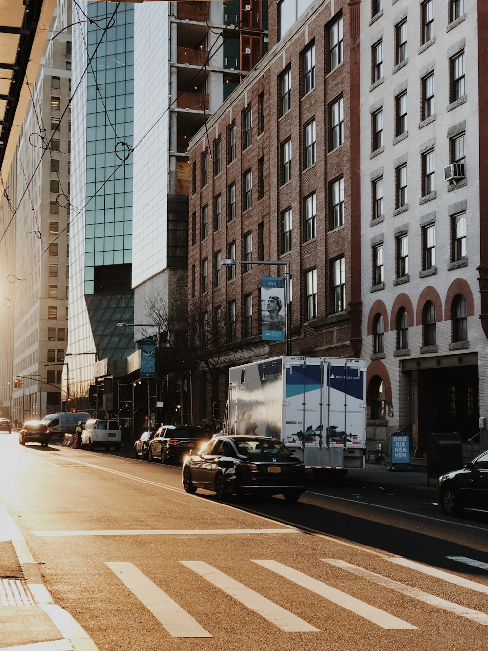 cars parked on side of the road near building during daytime