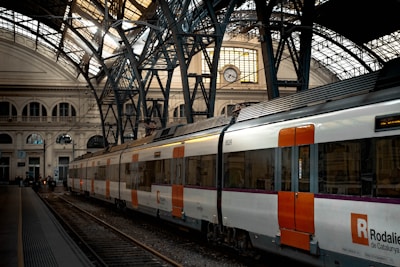 white red and black train on rail tracks