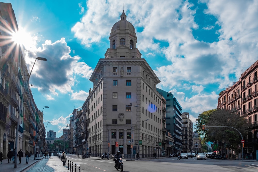 people walking on street near brown concrete building under blue sky during daytime