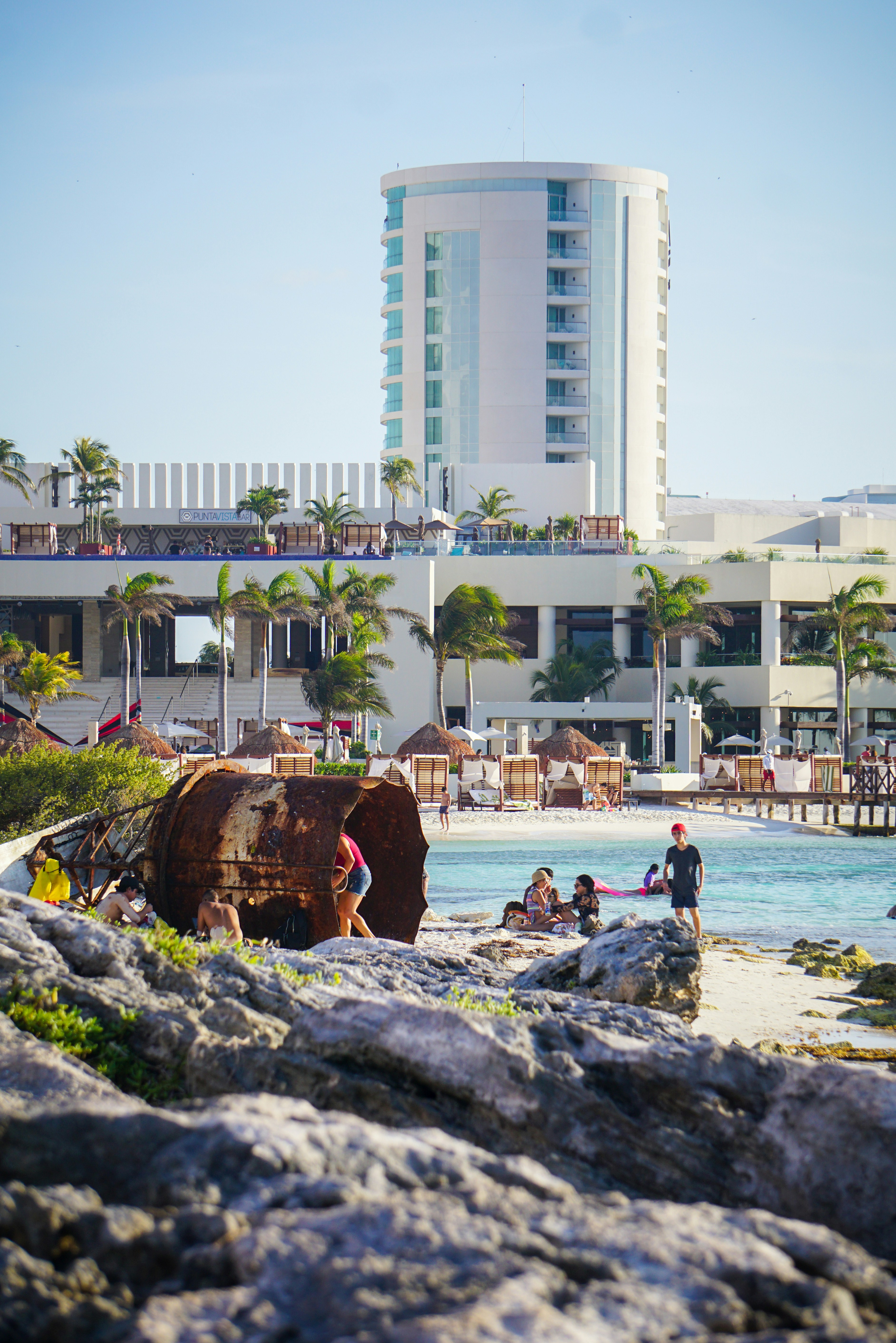 people on beach near high rise building during daytime