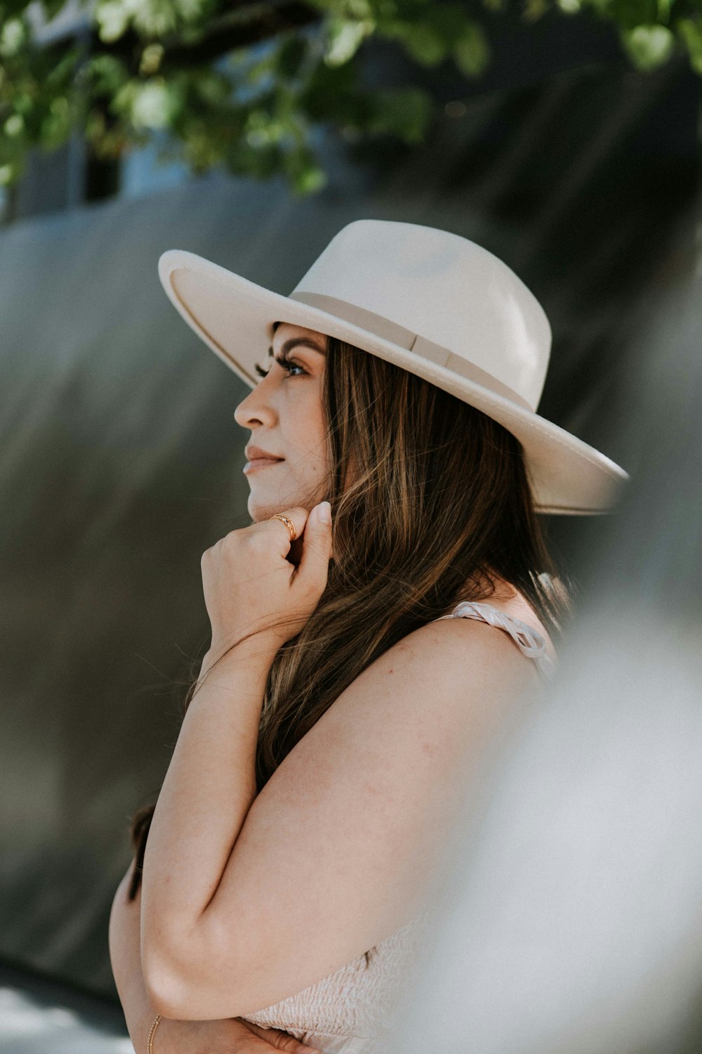 woman in white hat and white tank top