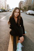 An outdoor shot of a model striking a casual pose on a city street.
