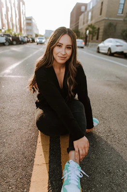 An outdoor shot of a model striking a casual pose on a city street.
