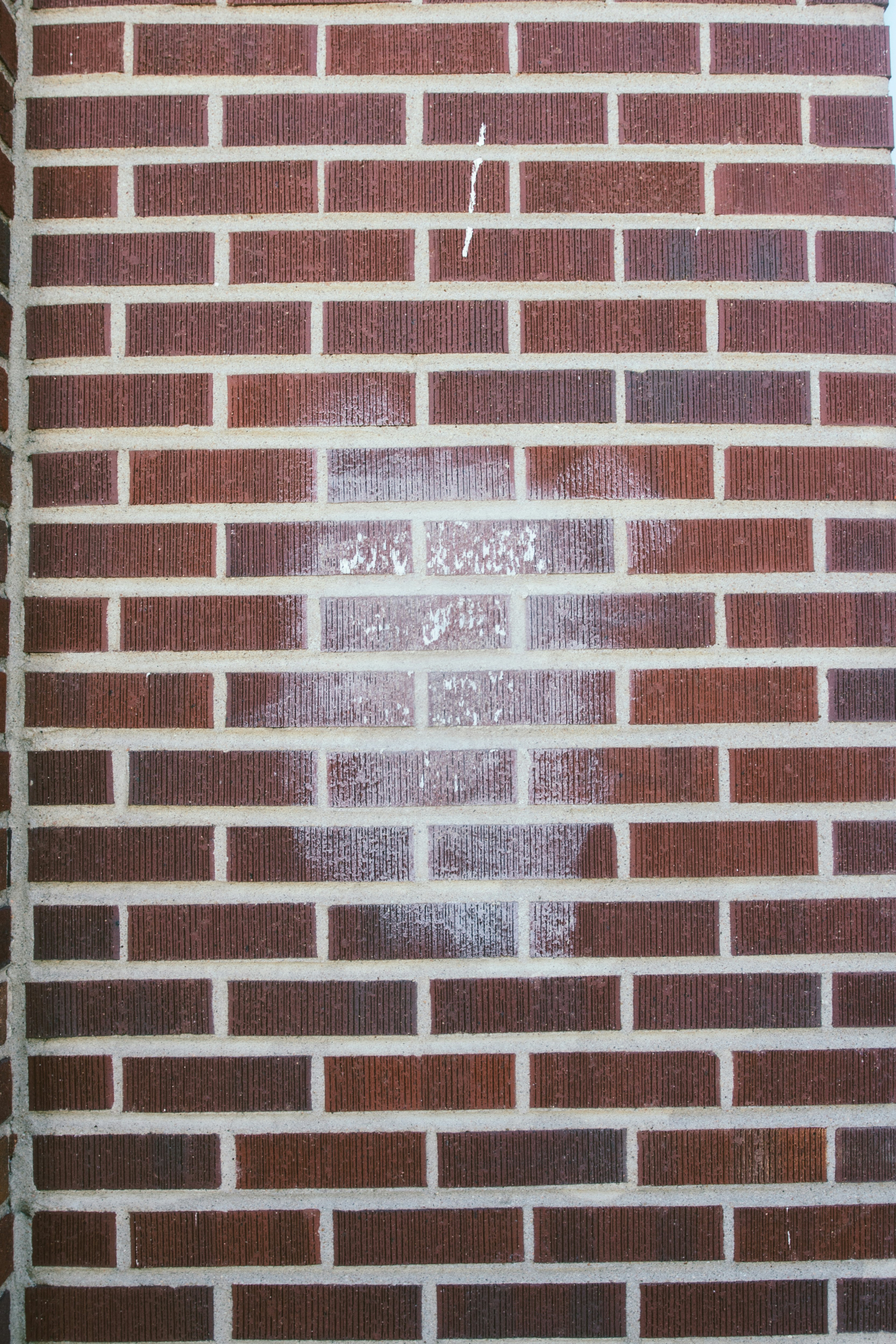 brown brick wall with white and red wall