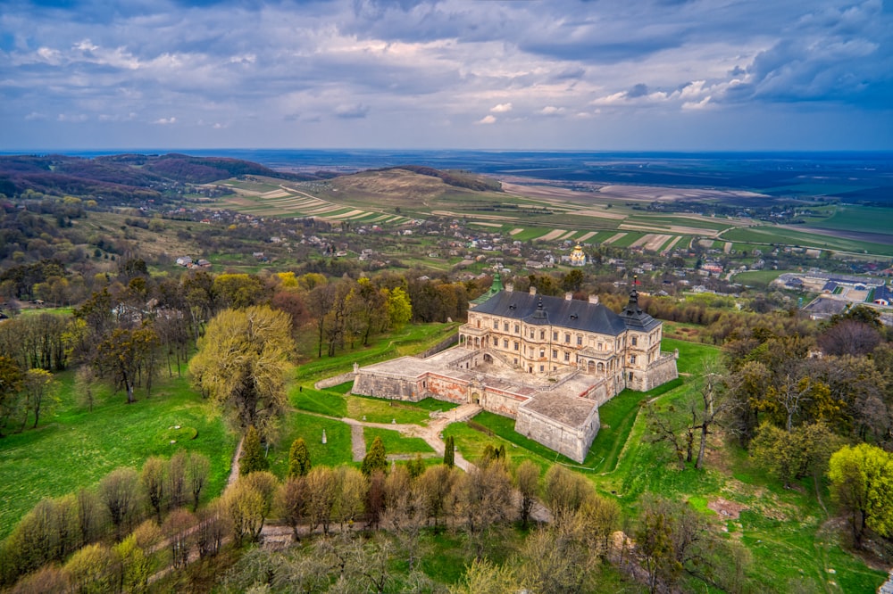 aerial view of green trees and white buildings during daytime