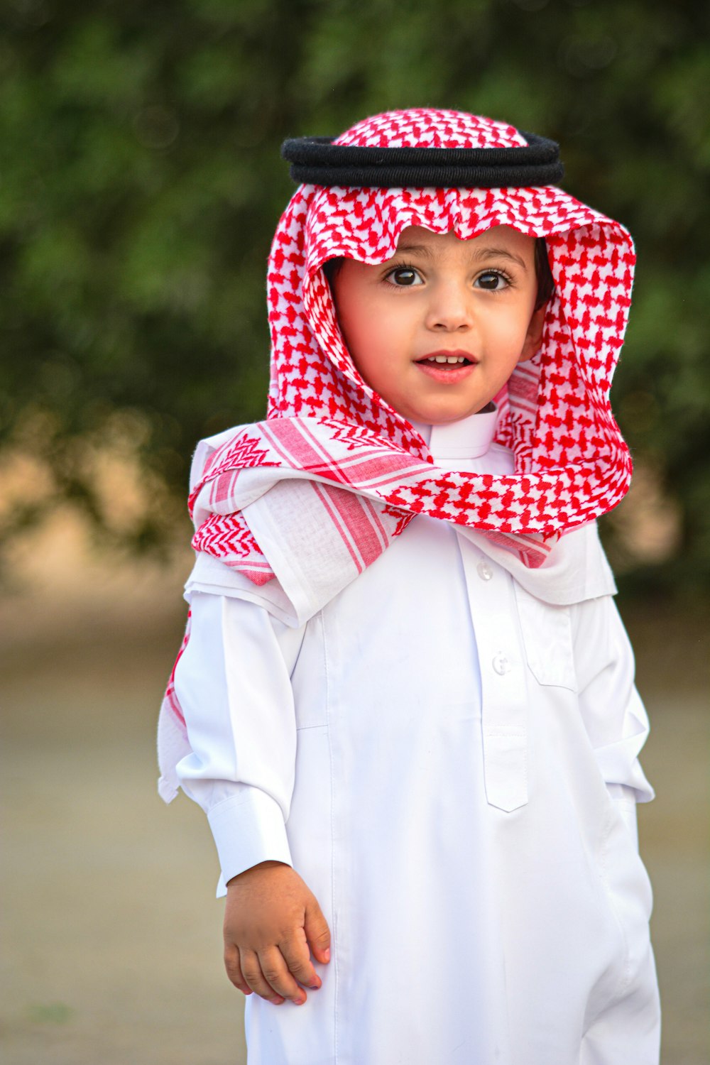 boy in white button up shirt wearing red and white plaid scarf