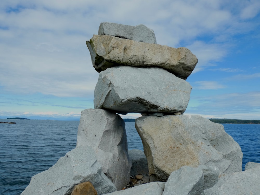 gray rock formation near body of water during daytime