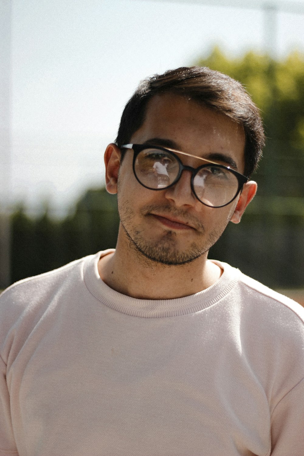 man in white crew neck shirt wearing black framed eyeglasses