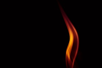 A single, elegant flame rises in a dark background, displaying a smooth, swirling motion in hues of orange, yellow, and red.