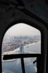 white and black airplane wing over the city during daytime