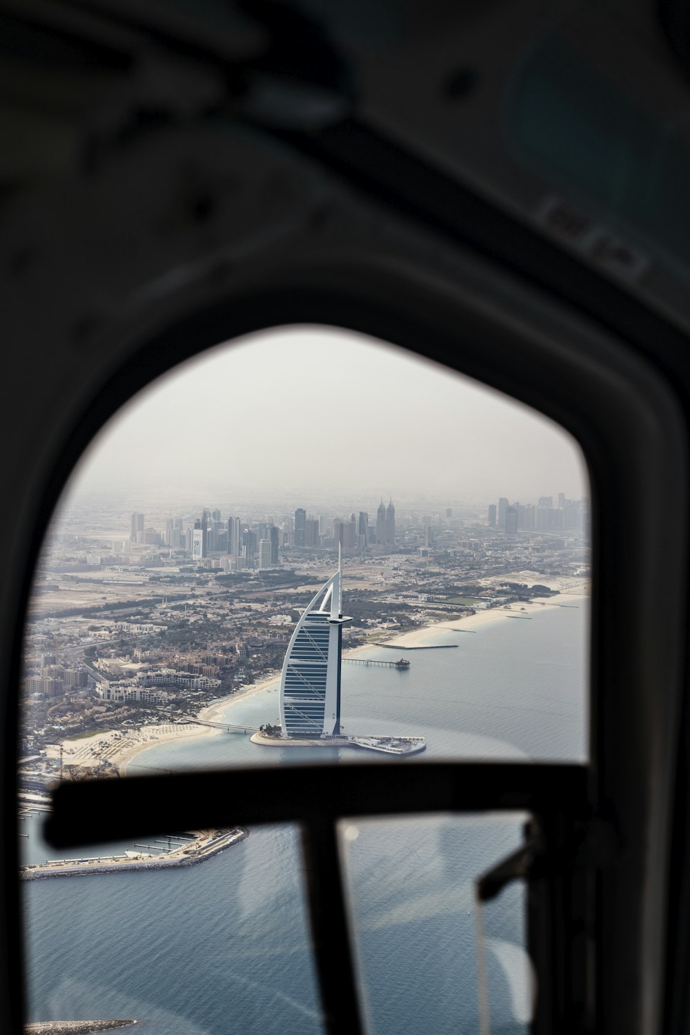 white and black airplane wing over the city during daytime