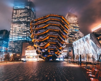 lighted building near body of water during night time