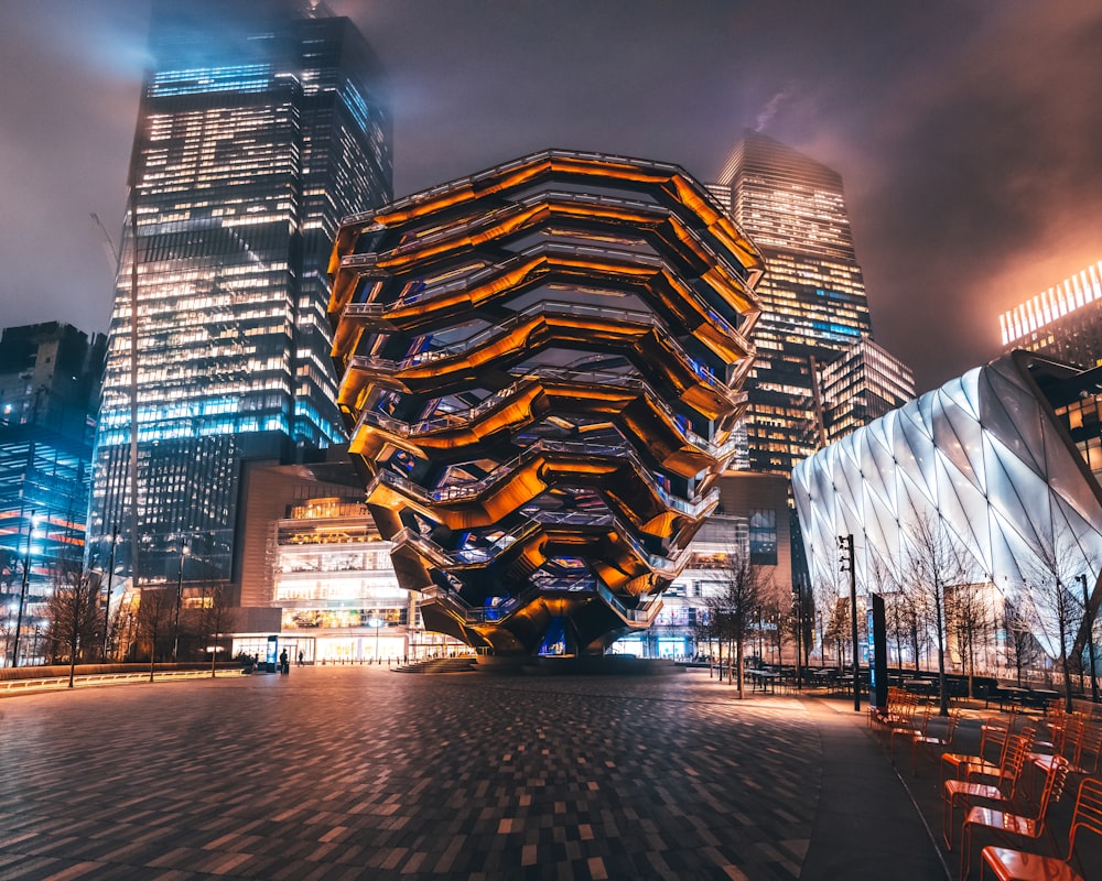 lighted building near body of water during night time