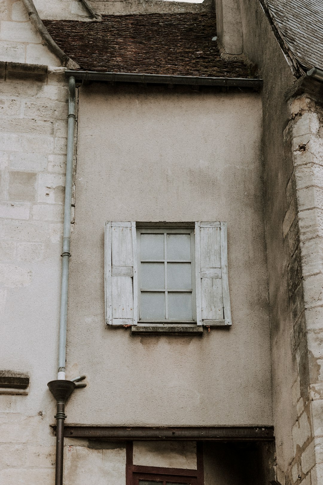 white wooden window on white concrete wall