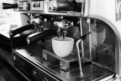 white ceramic mug on silver espresso machine