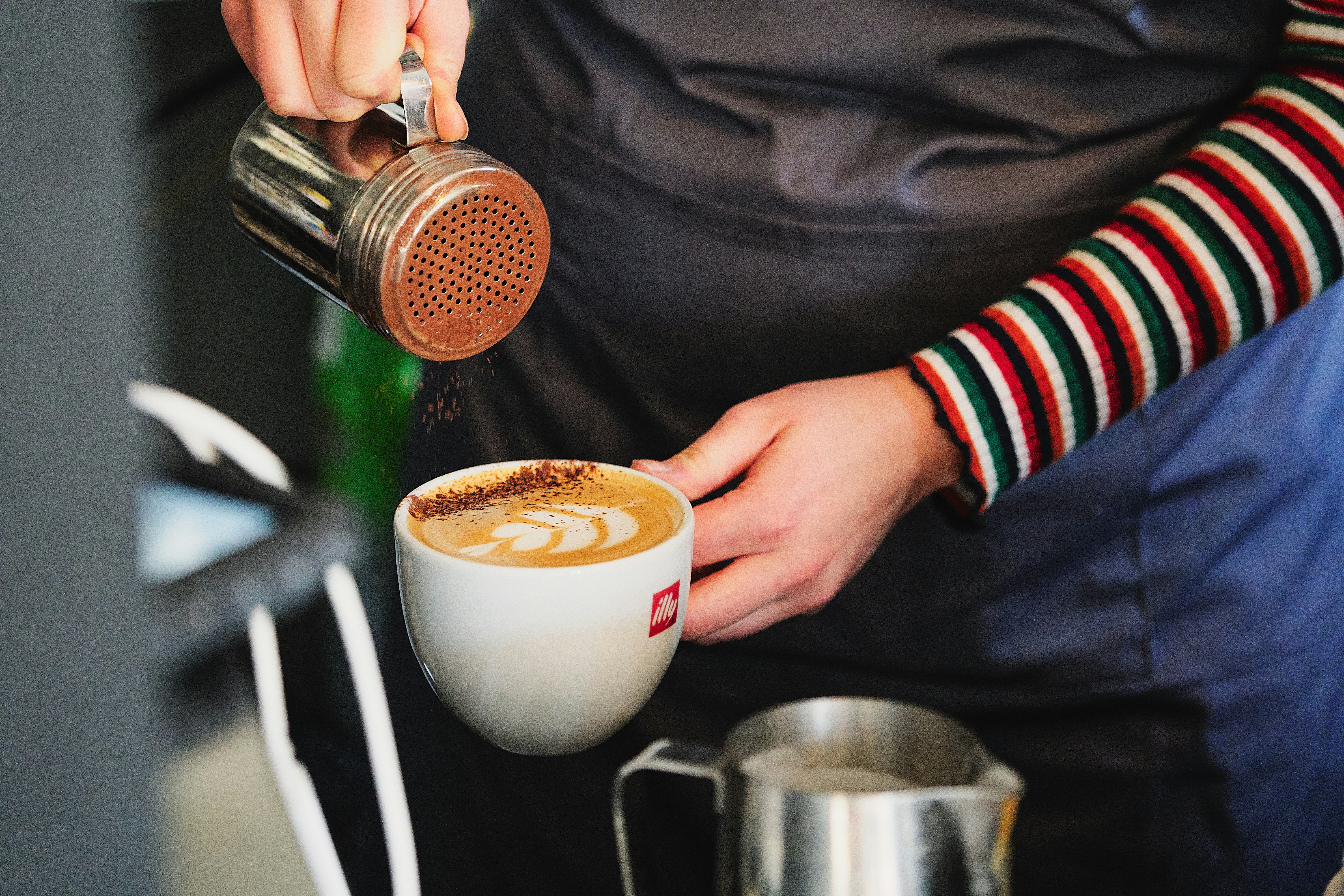 person holding white ceramic mug