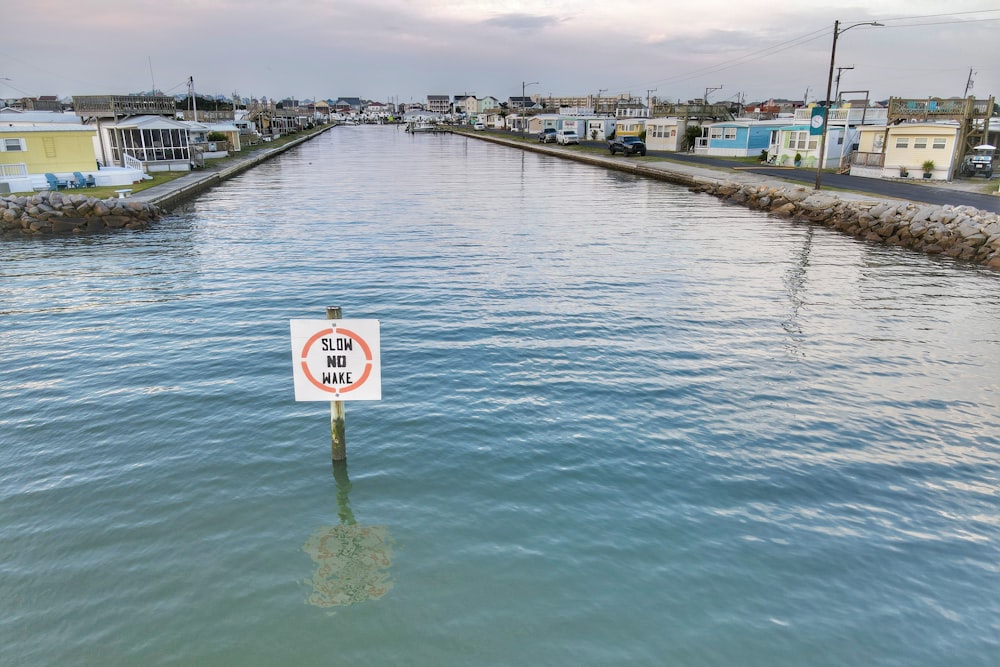 white and black no smoking sign on body of water during daytime