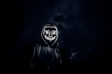 grayscale photo of man in black leather jacket wearing black and white helmet