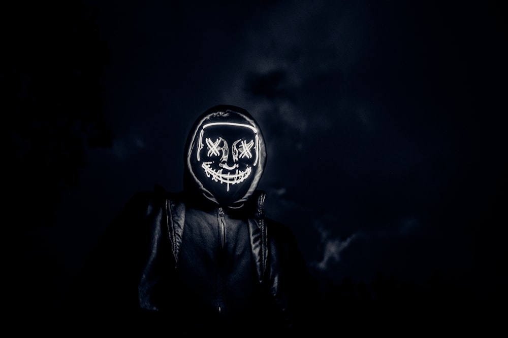 grayscale photo of man in black leather jacket wearing black and white helmet