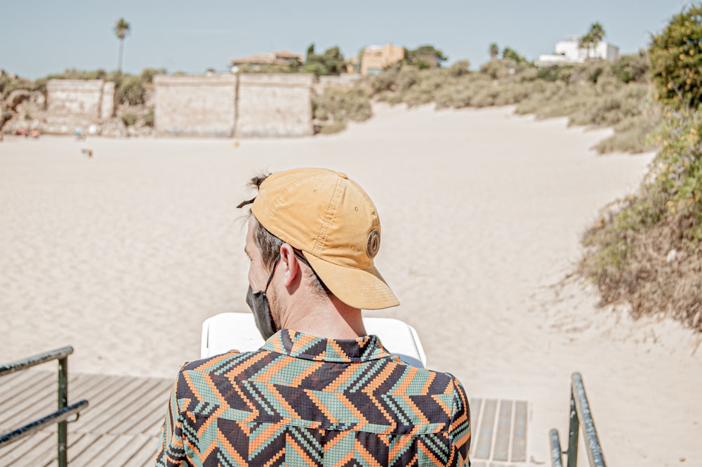 man in brown hat and blue white and red plaid shirt