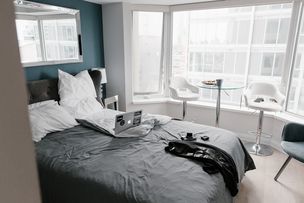 black bed linen near white wooden table