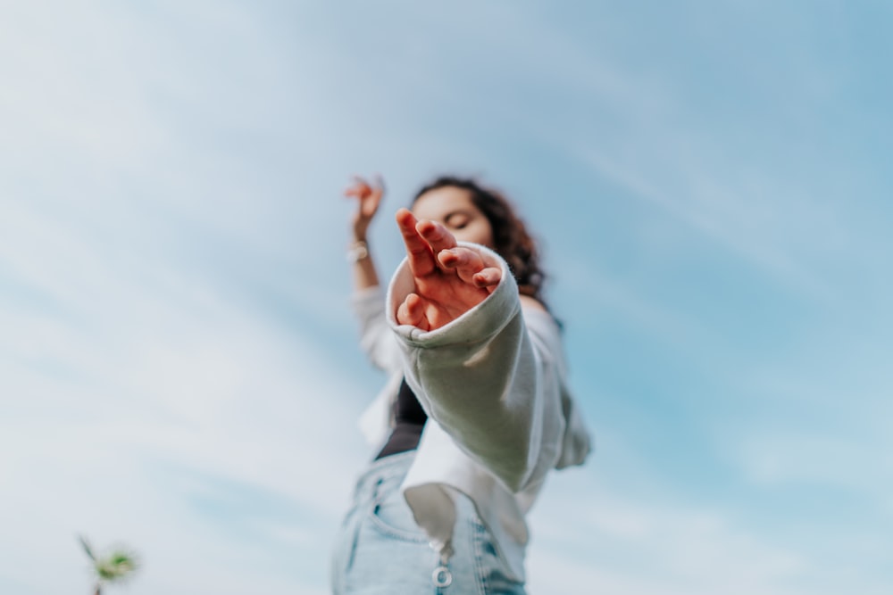 woman in white long sleeve shirt and white pants