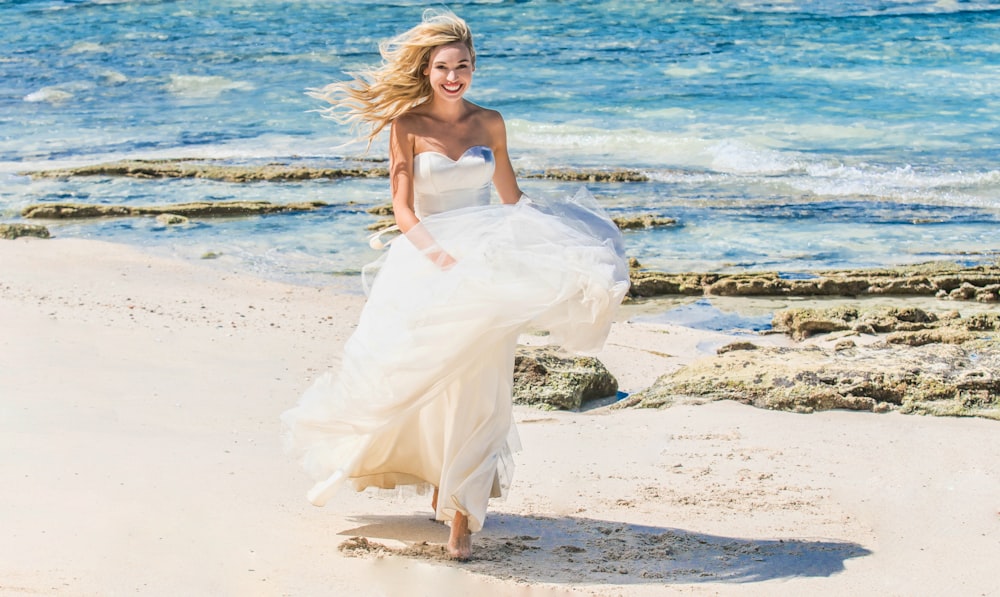 woman in white dress on beach during daytime