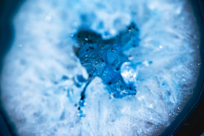 Close-up of a vibrant resin geode with shimmering blue and gold hues