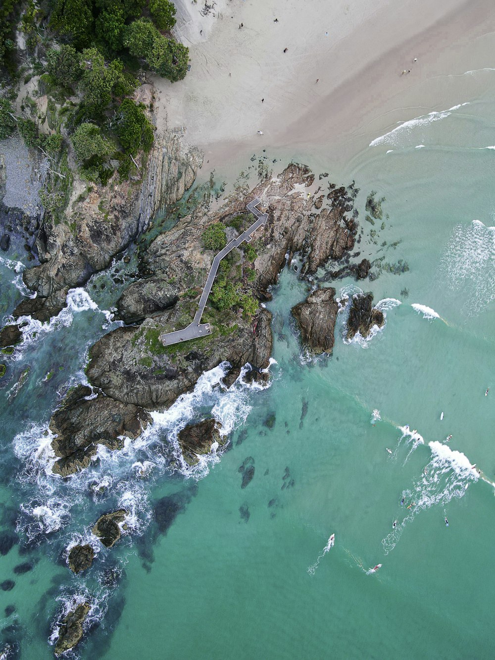 aerial view of green sea and brown mountain during daytime