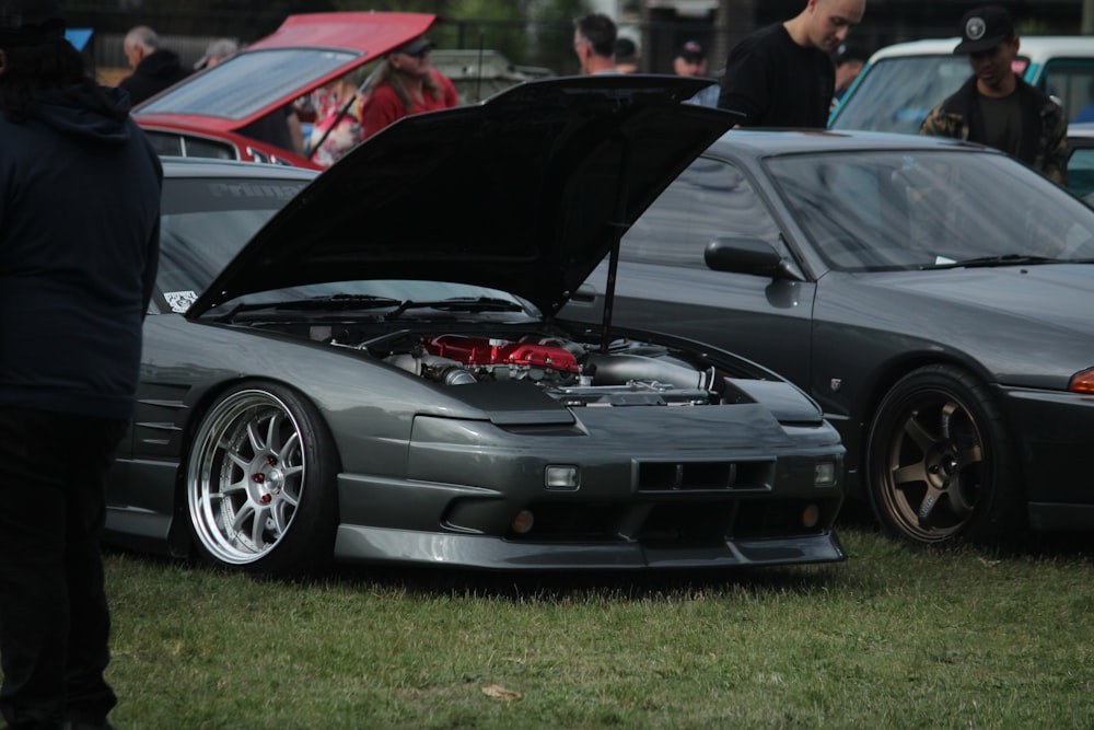 black bmw m 3 coupe parked on green grass field during daytime