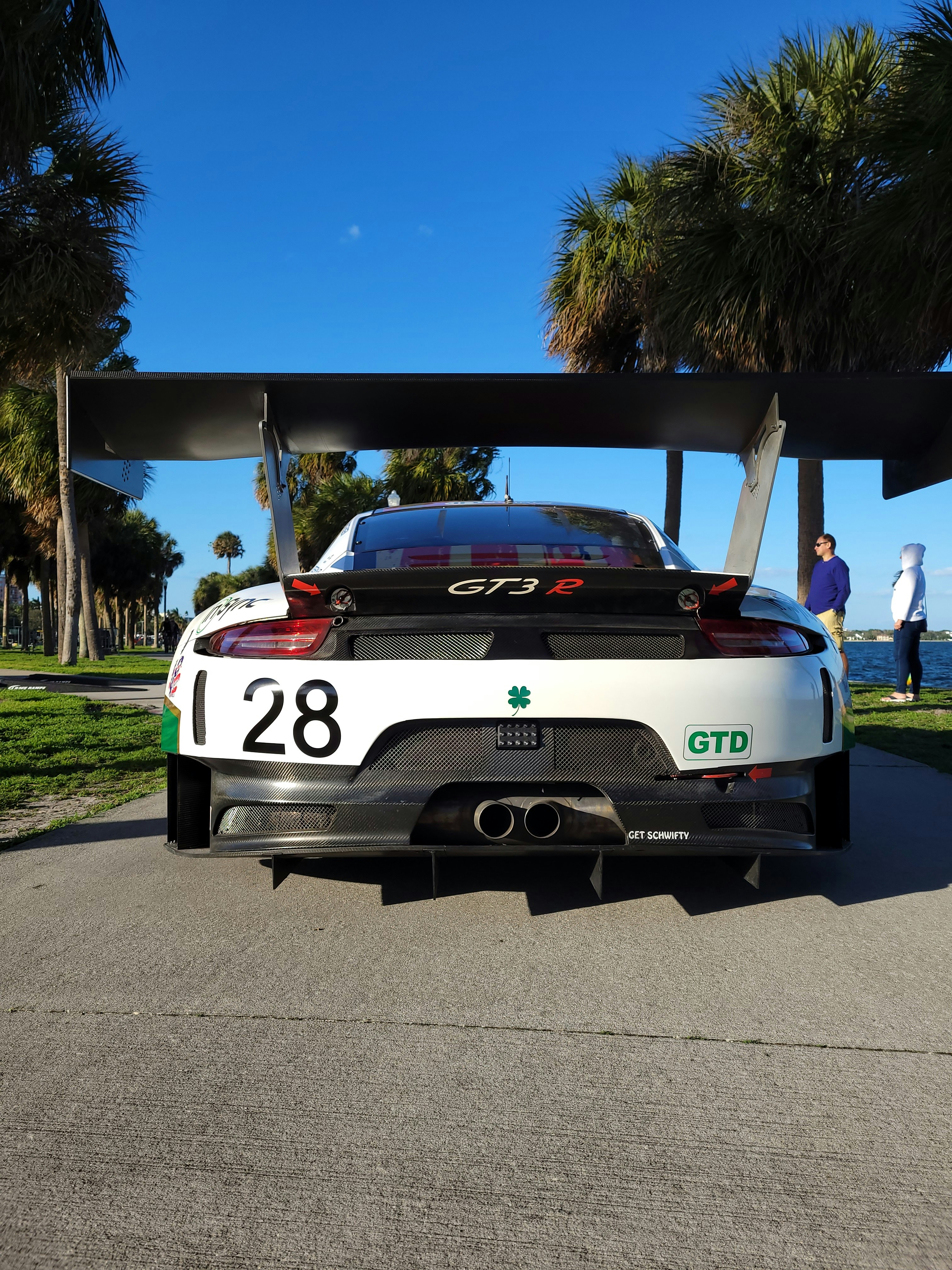 white and black chevrolet camaro on road during daytime