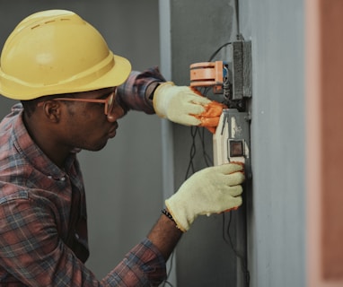 man in brown hat holding black and gray power tool