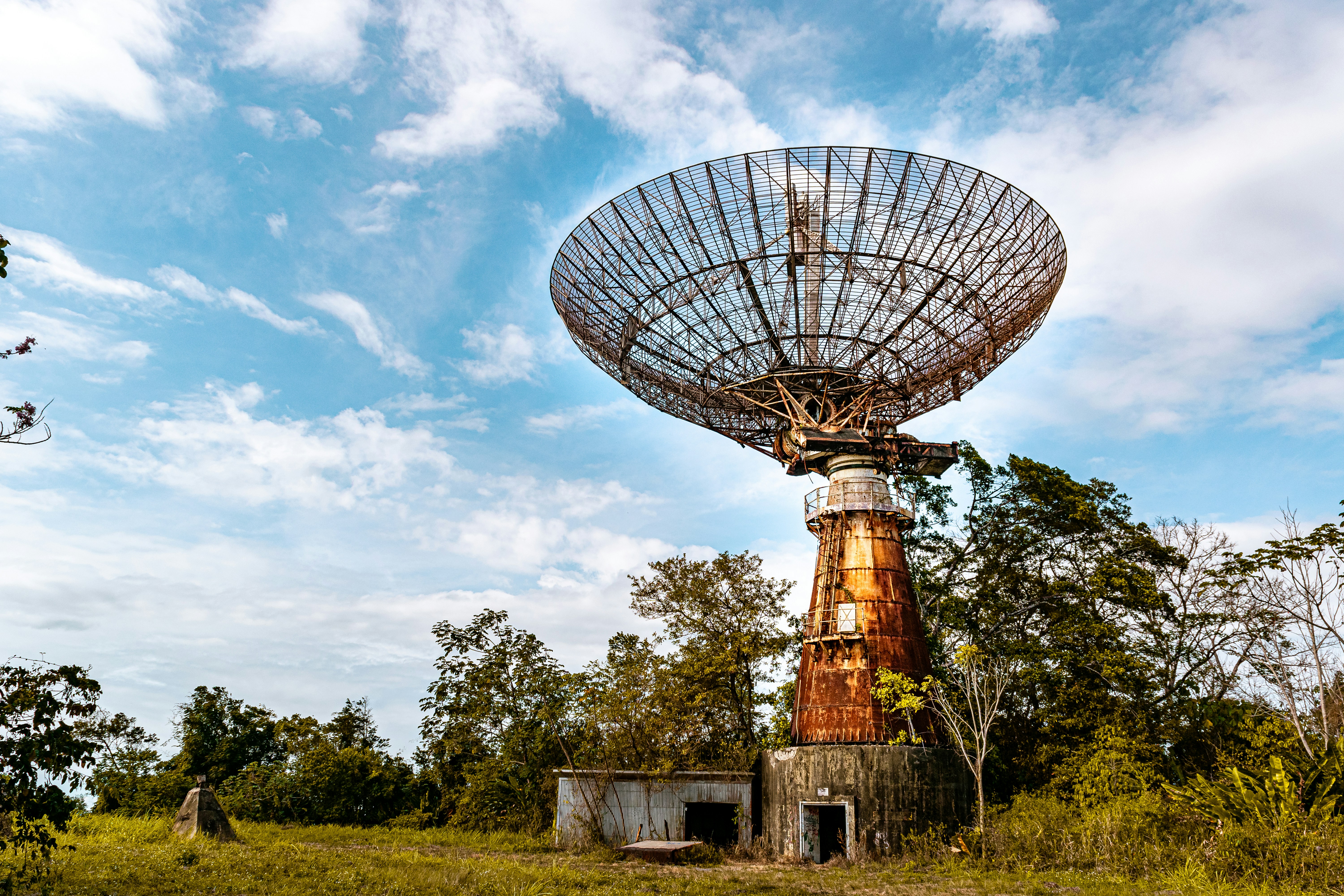 Historic site of the US Military Tracking Station in Chaguaramas, Trinidad covered with overgrown shrubs and tree