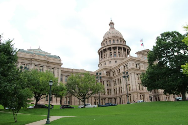 Brown concrete building near green grass field during daytime — Austin, United States
