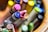 A close-up view of colorful crayons arranged in a container. The focus is on the tips of the crayons, showcasing a variety of colors including pink, blue, and yellow. The background is softly blurred, highlighting the vibrant colors of the crayons.