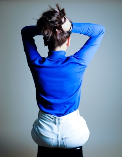 woman in blue long sleeve shirt and white denim shorts